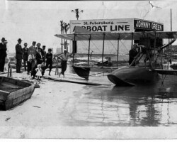 Crowd gathered beside a plane at Johnny Green Airboat Line Hangar, c. 1918.