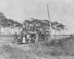 Peter Demens and his daughters pose next to Orange Belt Railway (OBRY) Locomotive No. 10. Note the OBRY logo on the train. c. 1888.